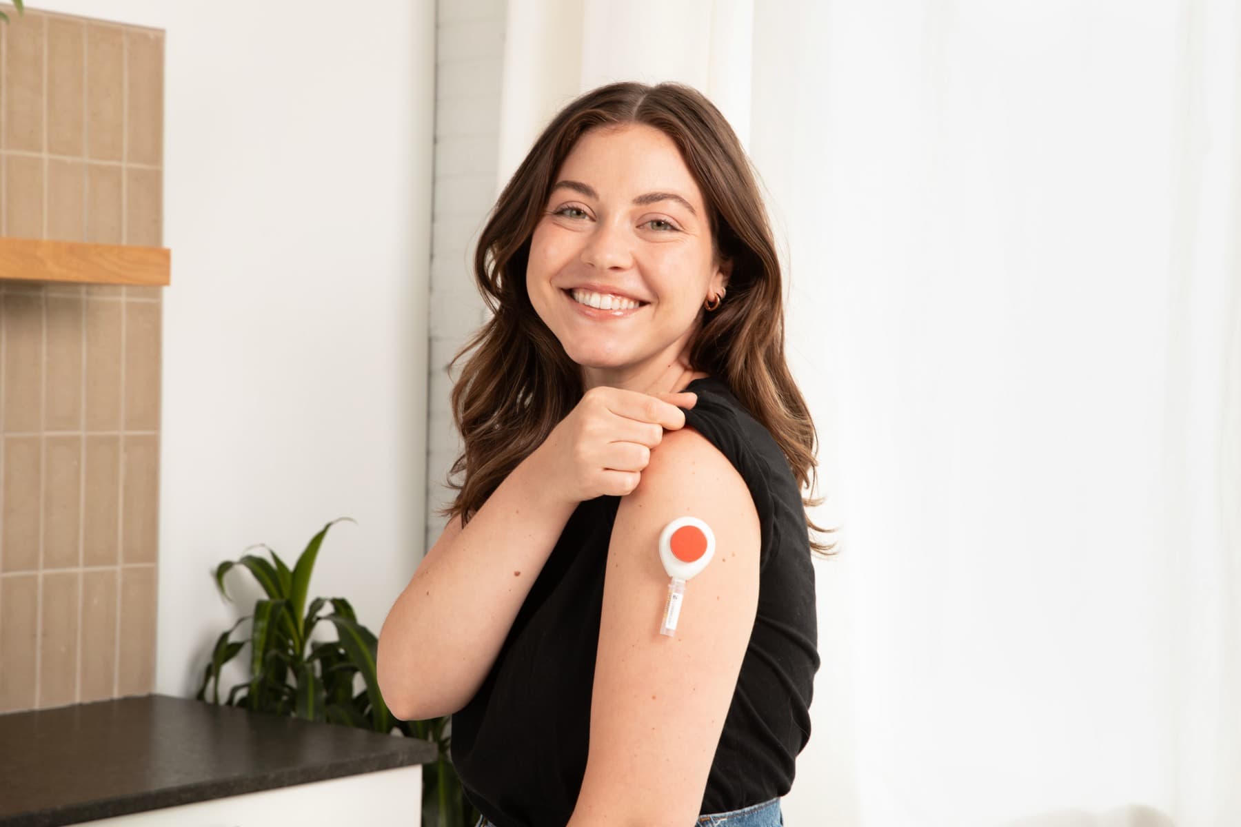 The Tasso+ at-home collection device on a person's arm